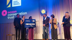 group holding large cheque on stage at presentation