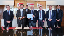 Men shaking hands and holding document